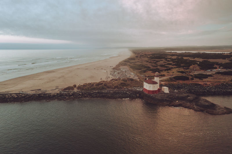 Dramatic and moody sky over bandon lighthouse, oregon, aerial photo