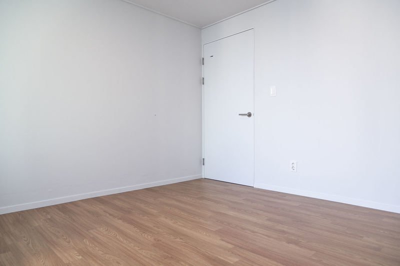 Empty wooden floor against wall at home