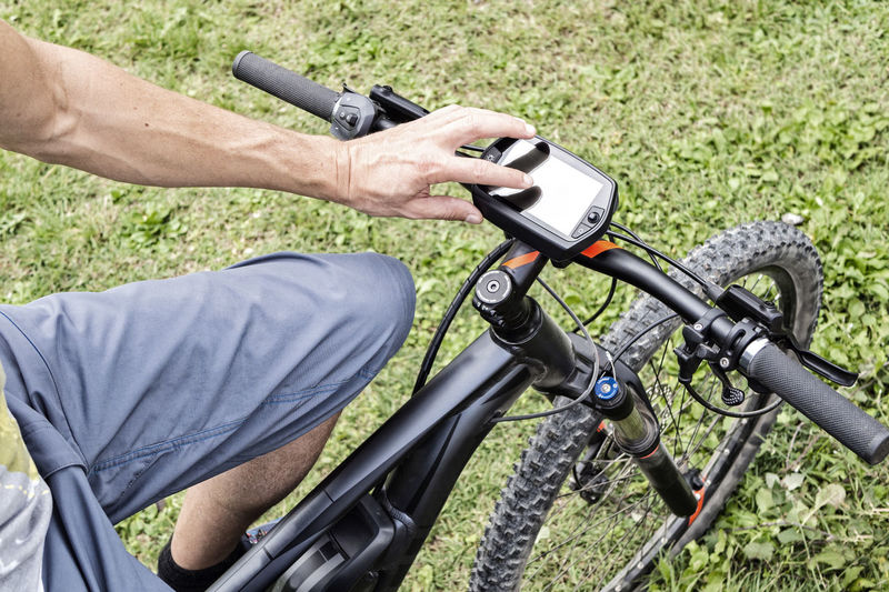 Men using gps device on a mountain bike