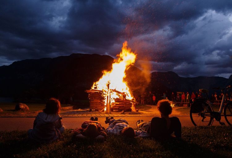 Bonfire on field against sky at night