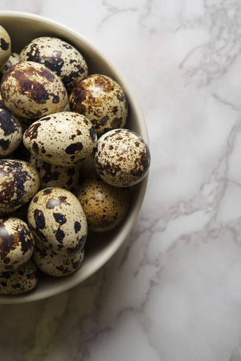 Quail eggs on a marble table.
