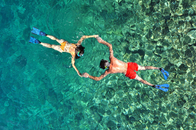 High angle view of people snorkeling in sea