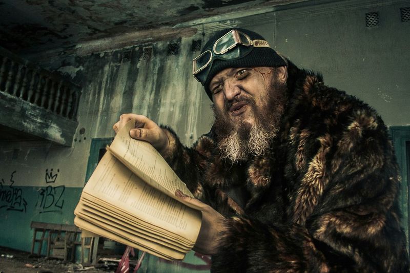 Man holding book in abandoned building
