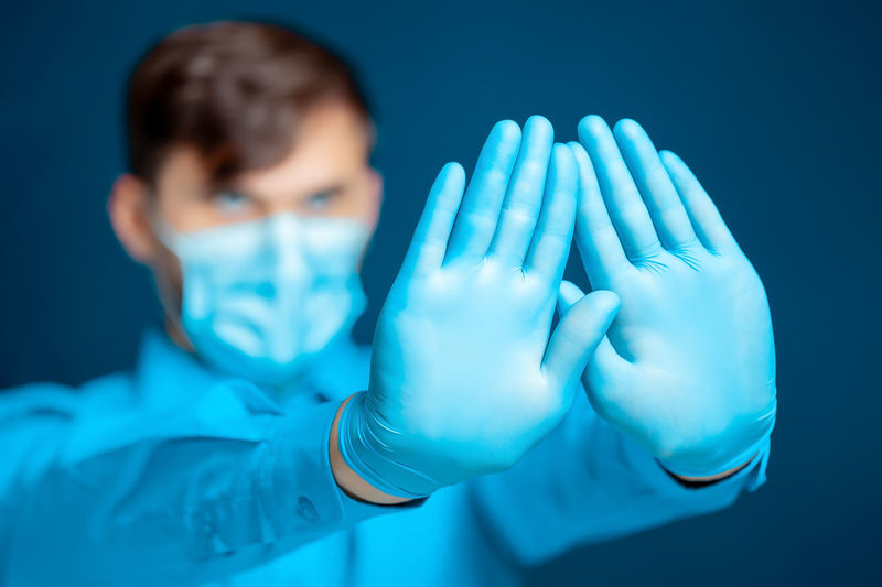 Doctor showing hands with gloves