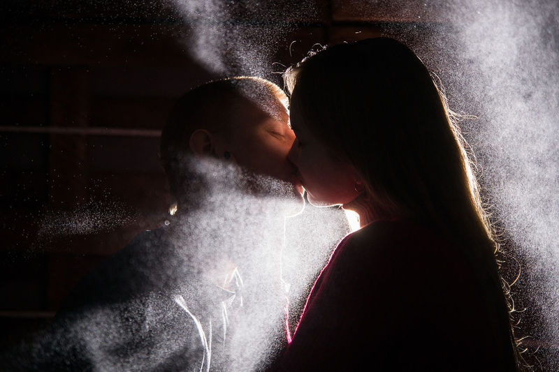 Close-up of couple kissing in darkroom