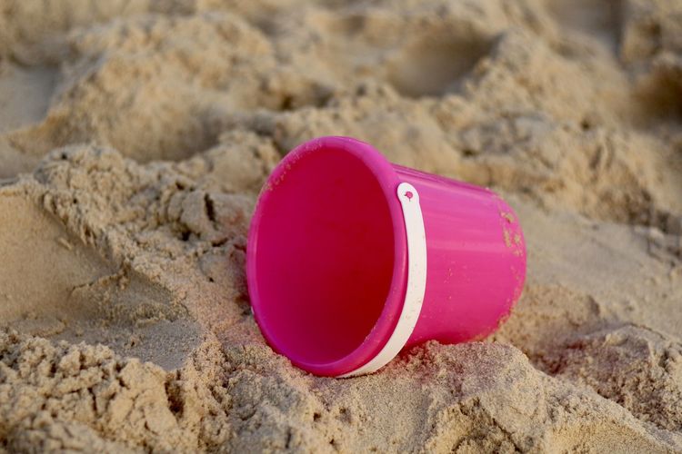 High angle view of pink toy on sand