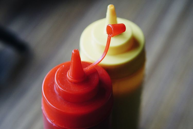 High angle view of ketchup and mustard bottles on table
