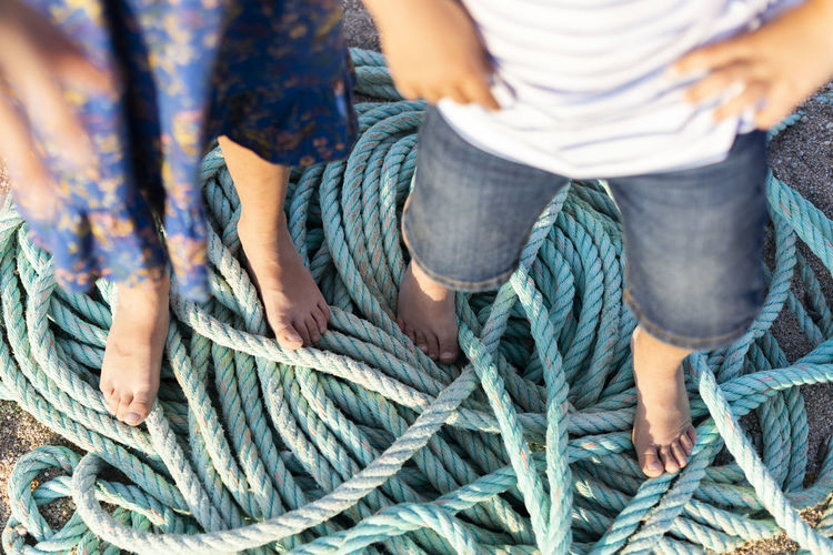 High angle view of friends tied up rope