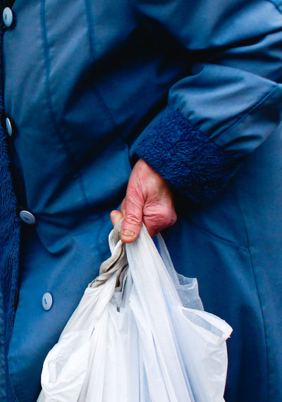 Midsection of woman holding shopping bag