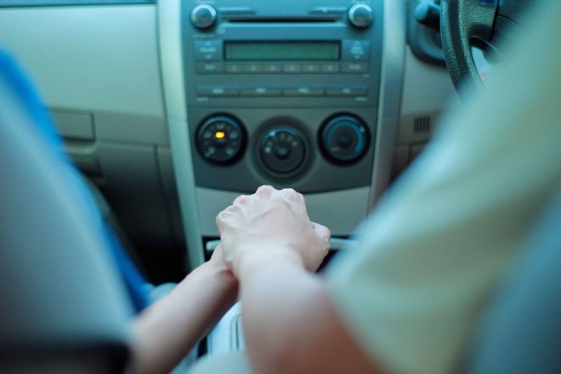 Lesbian couple holding hands in car