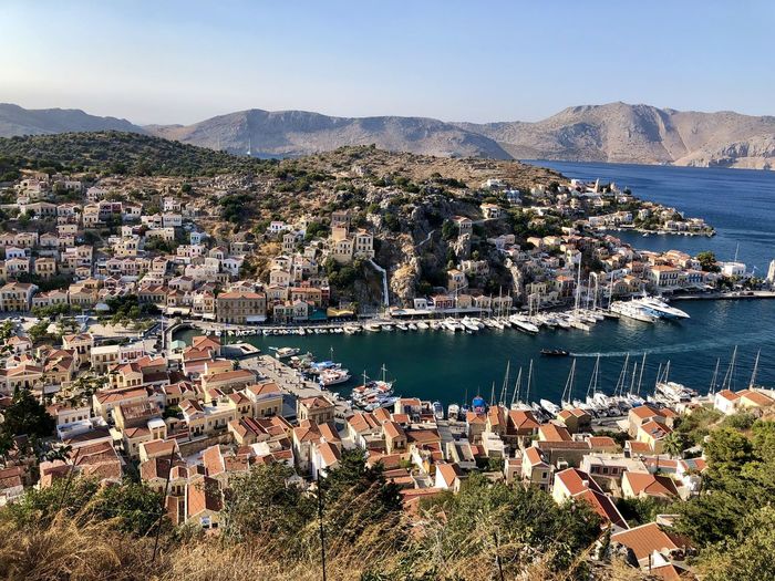Symi island panoramic view from the top of hill. marina, yachts, colourful houses, mountain.