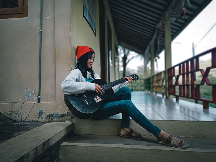 Side view of women playing guitar