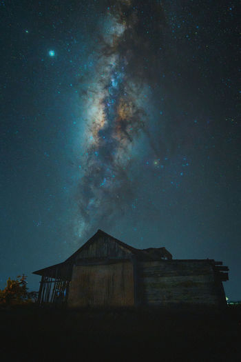 Low angle view of abandoned building against sky at night