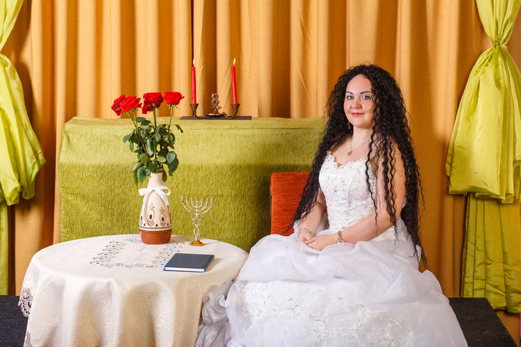 Portrait of bride sitting at home