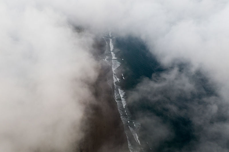 Aerial view of clouds covering sea