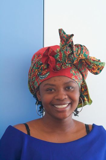 Portrait of a smiling young woman against gray background