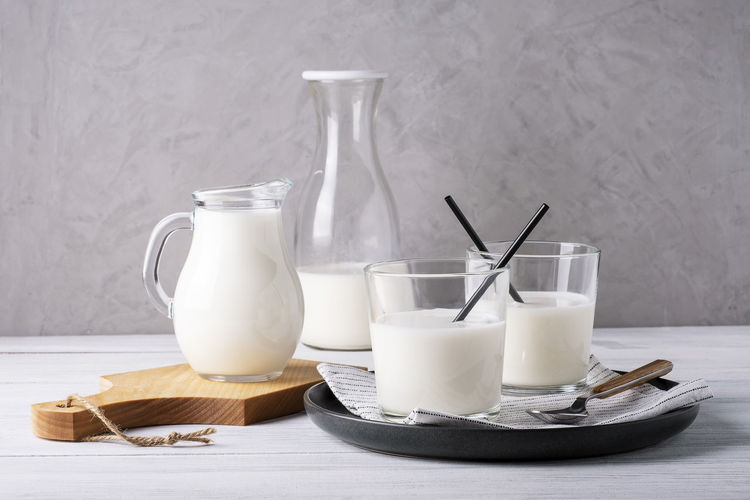 Composition of glass serving vessels with milk. healthy and dietary food, dairy products. 