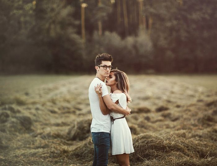 Couple hugging on field