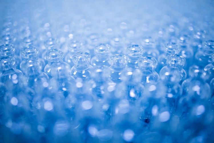 Close-up of water drops on glass table