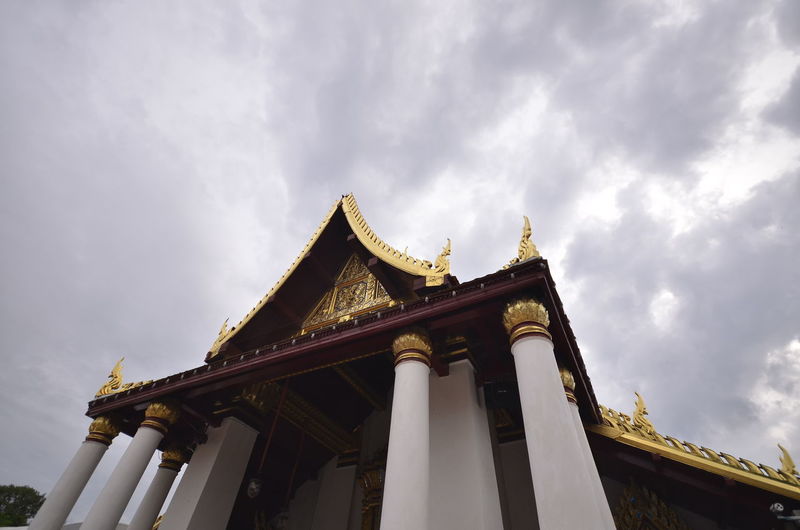 Low angle view of temple and building against sky