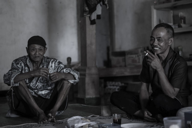 Two old men relaxing while enjoying a cigarette