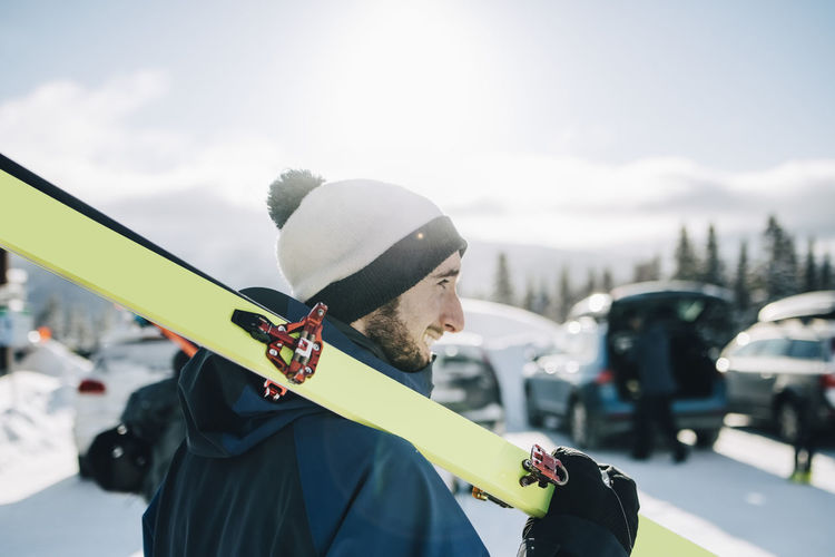 Bearded man with ski on sunny day during winter