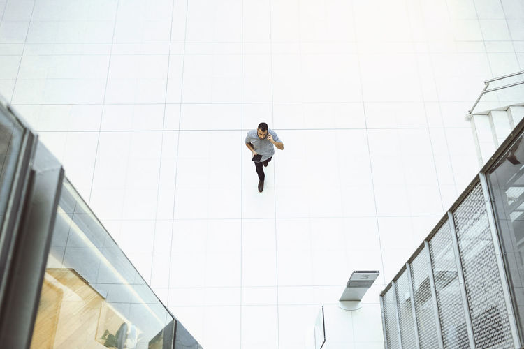 Low angle view of woman walking on building