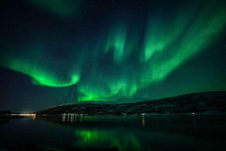 Scenic view of lake against sky at night