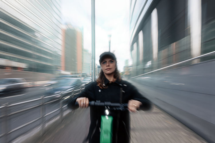 Real moving picture of a woman driving an electric scooter along a reserved fast track