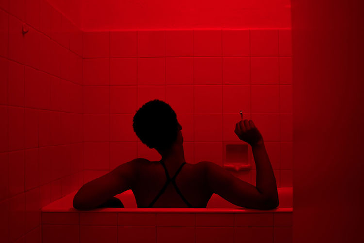 A Lady Smokes as she reflect on the year. Lady Reflection Smoking TheWeekOnEyeEM A7sii Addiction Bathroom Day Digital Art Indoors One Person People Real People Rear View Red Smoking Weed Sony Young Adult The Week On EyeEm Editor's Picks The Portraitist - 2018 EyeEm Awards HUAWEI Photo Award: After Dark