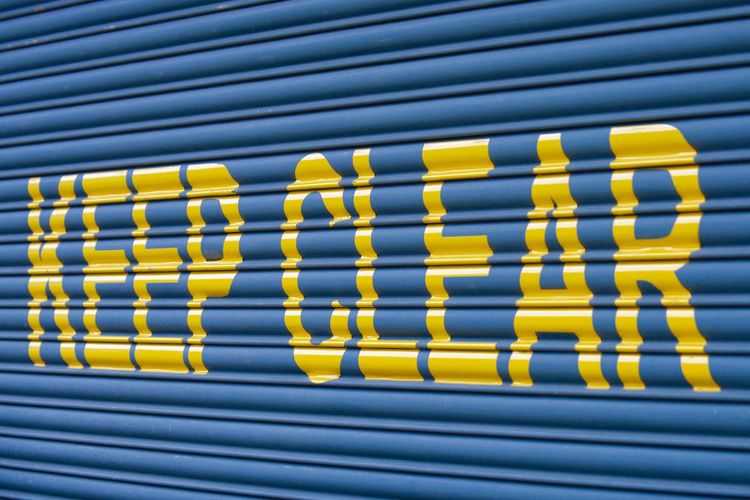 Yellow keep clear sign on blue shutter