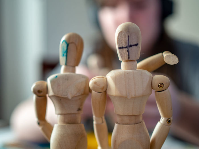 Close-up of wooden figures with blurred background