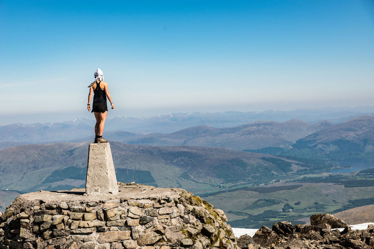 Man standing on mountain against sky