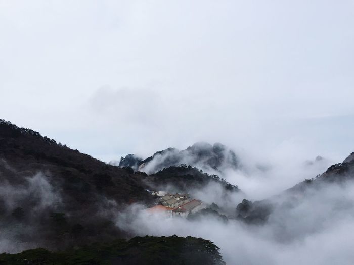 Scenic view of huangshan mountains against sky during foggy weather