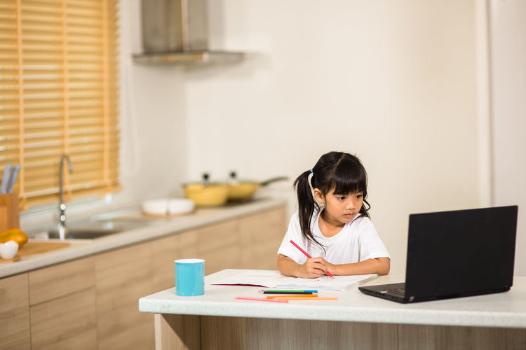 Cute girl studying at home