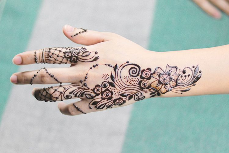 Close-up of woman hand with henna tattoo