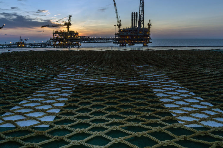 Sunset at oil filed from a helipad of a construction barge