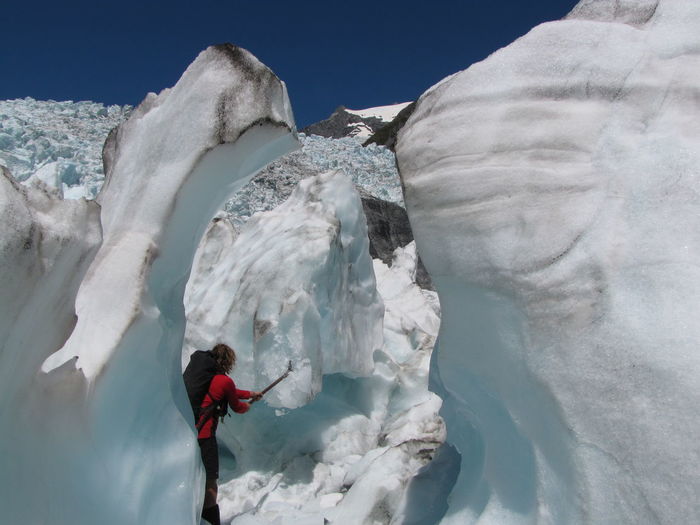 Woman standing on glacier