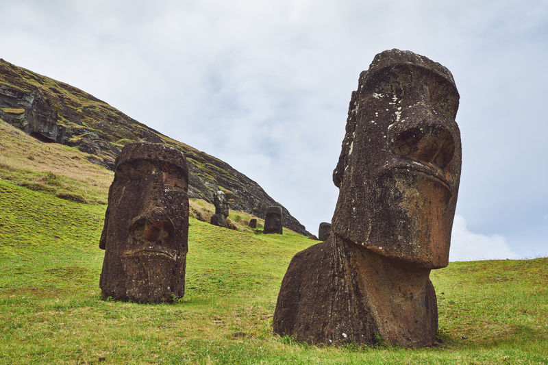 View of moai statue on field against sky