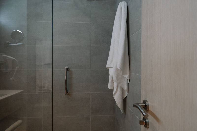 Towel hanging on wall in bathroom at home