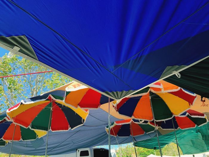 Low angle view of tent against blue sky