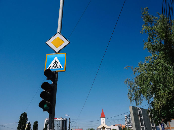 High section of traffic light against blue sky