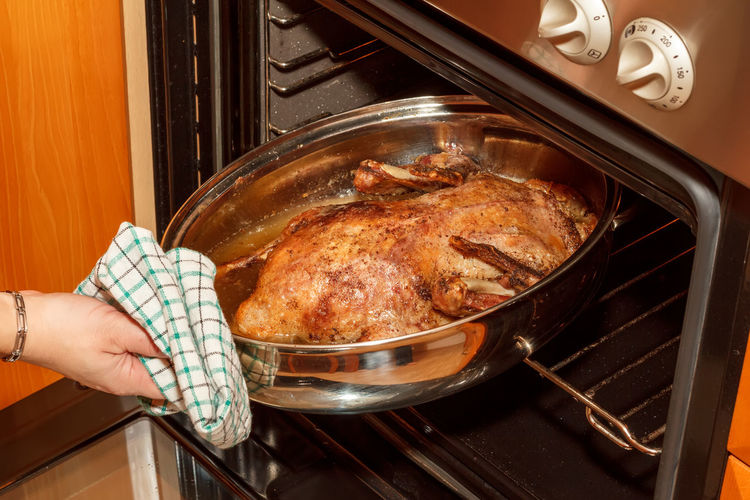 Midsection of person preparing food in kitchen