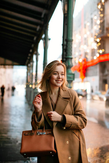 Portrait of a smiling young woman in city