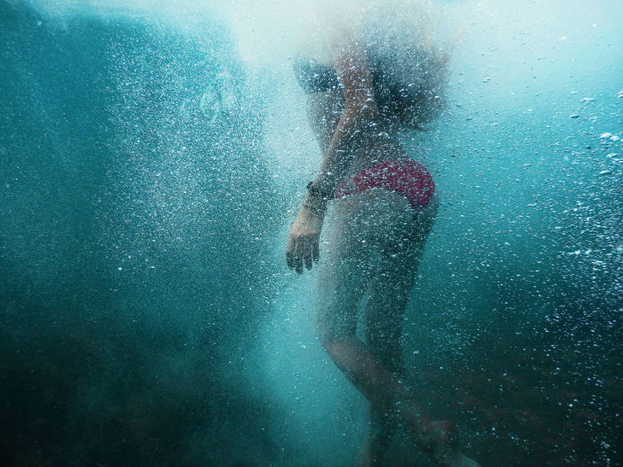 Young woman swimming in undersea