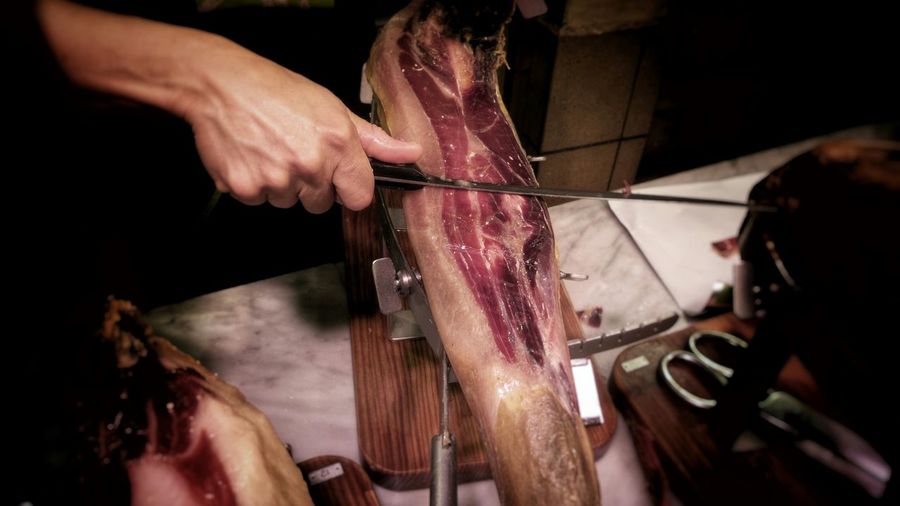 Butcher hand cutting steak