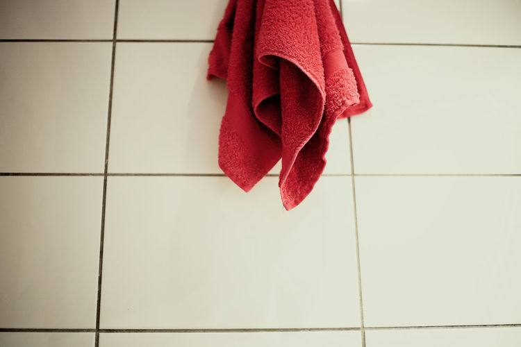 Close-up of red umbrella hanging on wall