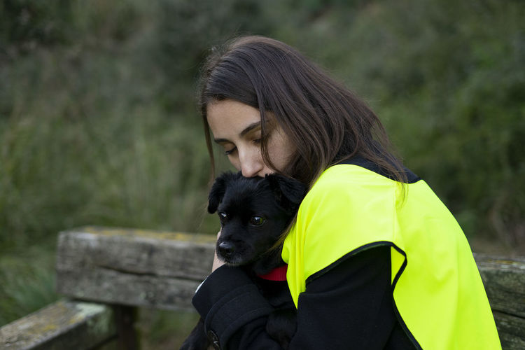 Kennel volunteer hugging an abandoned dog.