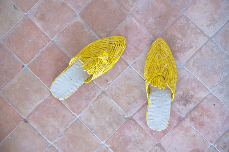 Yellow slippers on a brick floor
