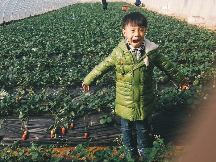 Portrait of boy in greenhouse
